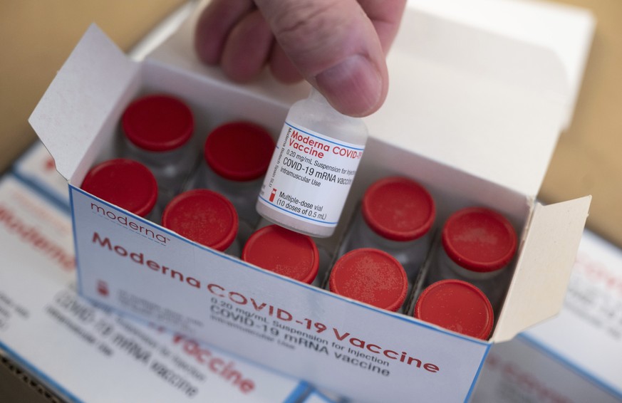 A man shows a vial of a Covid-19 vaccine from Moderna intended for the vaccination centre of the Klinikum in Stuttgart, Germany, Thursday, Jan. 14, 2021. (Marijan Murat/dpa via AP)