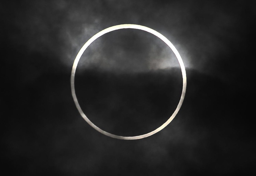 An annular solar eclipse in seen from Machida, on the outskirts of Tokyo, Monday, May 21, 2012. Millions across Asia are watching as a rare &quot;ring of fire&quot; eclipse is crossing their skies. Th ...