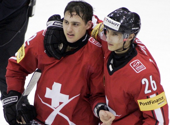 Switzerland&#039;s Nino Niederreiter, left, is congratulated by Pascal Marolf on his overtime goal against Russia during a quarterfinal game at the World Junior Hockey championships Saturday, Jan 2, 2 ...