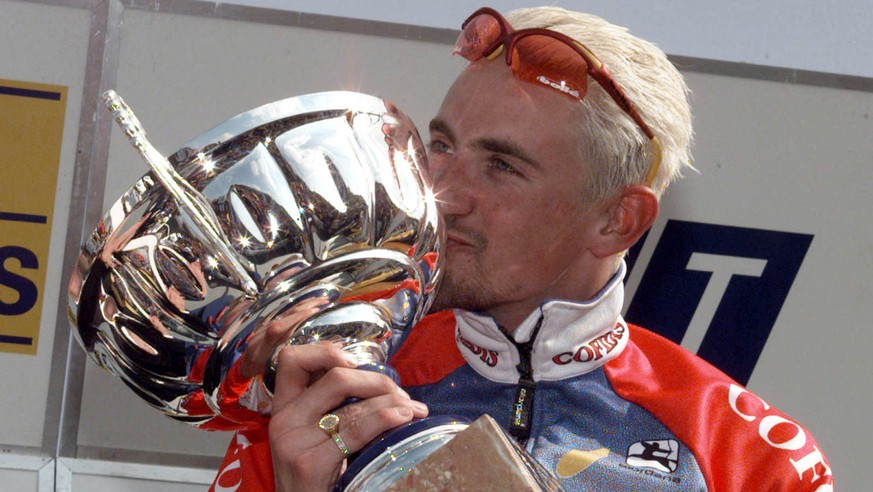 Belgian Frank Vandenbroucke kisses his trophy during the podium ceremony after winning the Liege-Bastogne-Liege cycling classic race in Liege Sunday afternoon, April 18, 1999. (AP PHOTO/ Gerard Guissa ...