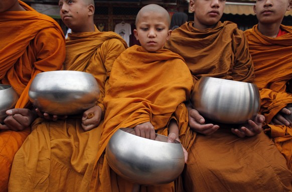 Novice Buddhist monks wait for alms during Buddha Jayanti, or Buddha Purnima festival in Kathmandu, Nepal, Saturday, May 21, 2016. The festival marks the triple events of Gautam Buddha&#039;s life: hi ...