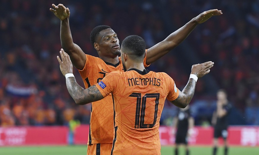 Denzel Dumfries, left, of the Netherlands celebrates with his teammate Memphis Depay of the Netherlands after scoring his side&#039;s second goal during the Euro 2020 soccer championship group C match ...