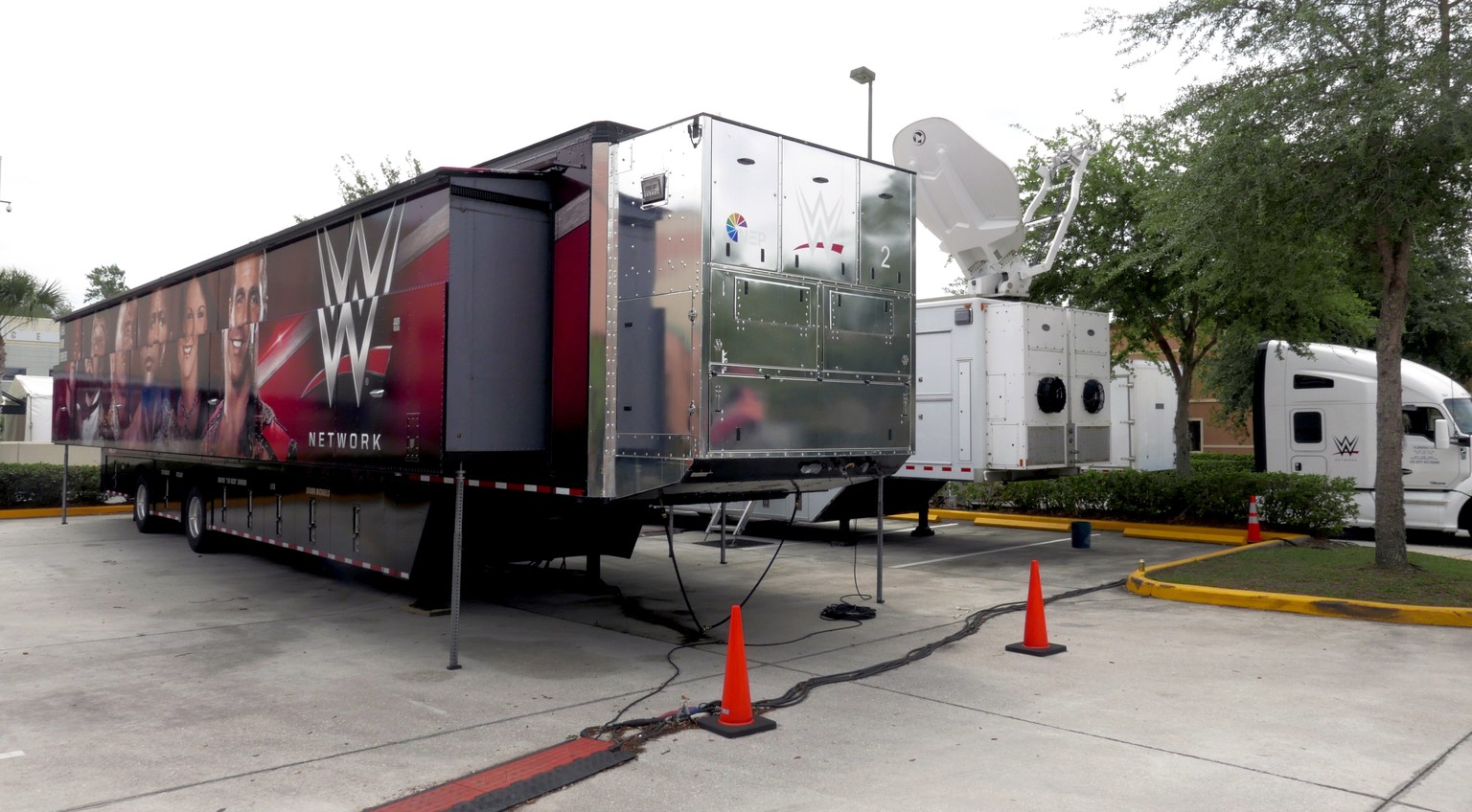 A trailer and a satellite truck to transmit wrestling broadcasts are parked outside the WWE Performance Center Tuesday, April 14, 2020, in Orlando, Fla. FloridaÄôs top emergency official last week am ...