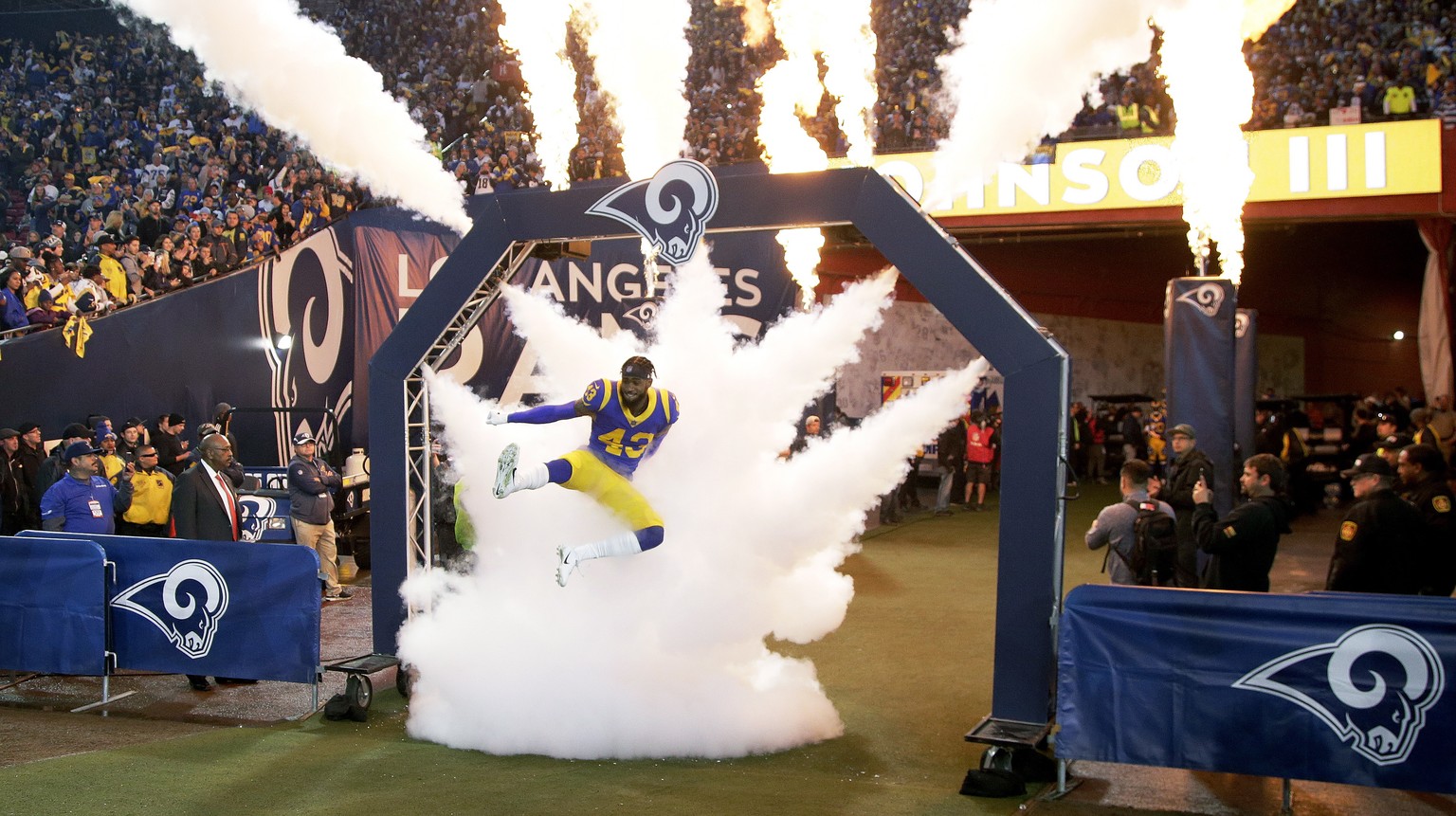 epaselect epa07279298 Los Angeles Rams strong safety John Johnson leaps through smoke prior to the start of the NFC Divisional Round playoff NFL American Football game between the Los Angeles Rams and ...