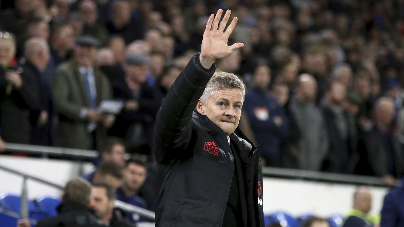 Manchester United Interim Manager Ole Gunnar Solskjaer gestures to fans during the English Premier League soccer match between Cardiff City and Manchester United at the Cardiff City Stadium, in Cardif ...