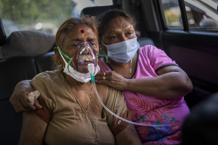 A COVID-19 patient receives oxygen inside a car provided by a Gurdwara, a Sikh house of worship, in New Delhi, India, Saturday, April 24, 2021. India