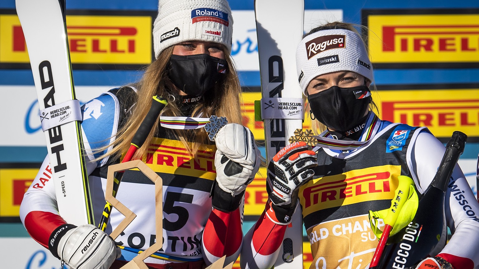 Corinne Suter of Switzerland and Lara Gut-Behrami of Switzerland celebrate with the Silver and Gold medals for Super-g race during the medals ceremony after the women&#039;s Super-G race at the 2021 F ...