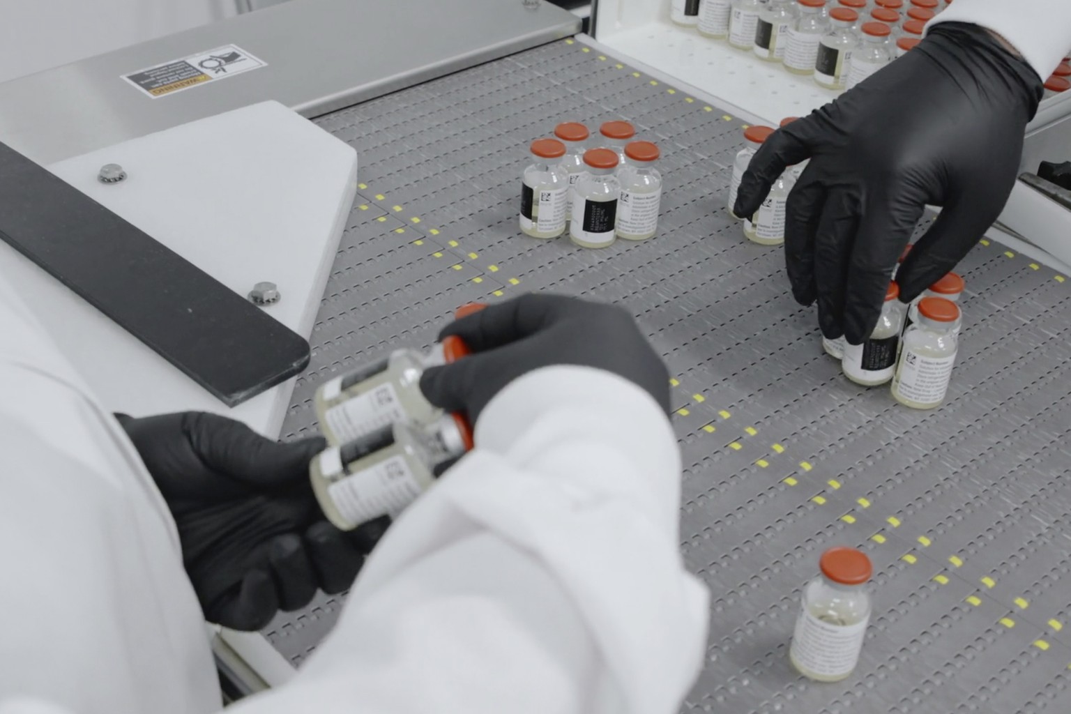 In this undated image from video provided by Regeneron Pharmaceuticals on Friday, Oct. 2, 2020, vials are inspected at the company&#039;s facilities in New York state, for efforts on an experimental c ...
