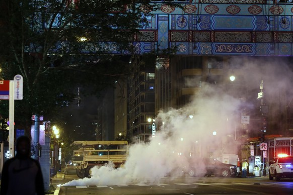 Police deploy teargas near the Chinatown arch in downtown as demonstrators protest the death of George Floyd, Monday, June 1, 2020, near the White House in Washington. Floyd died after being restraine ...