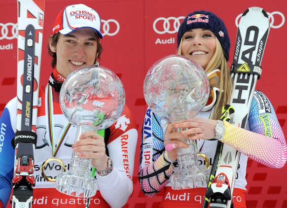 Lindsey Vonn of the United States, right, and Switzerland&#039;s Carlo Janka hold their trophies of the alpine ski, Women&#039;s and Men&#039;s World Cup overall title, in Garmisch-Partenkirchen, Germ ...
