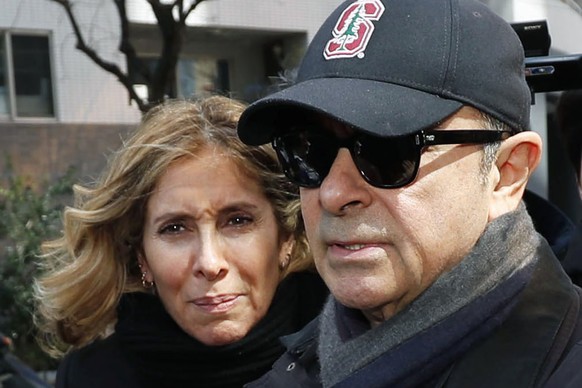 FILE - This March, 2019, file photo shows former Nissan Chairman Carlos Ghosn, right, and his wife Carole in Tokyo. Ghosn, awaiting trial in Japan on financial misconduct charges, has received permiss ...