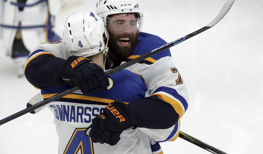 St. Louis Blues&#039; Carl Gunnarsson (4), of Sweden, is congratulated by Pat Maroon, rear, after he scored the winning goal against the Boston Bruins during the first overtime period in Game 2 of the ...