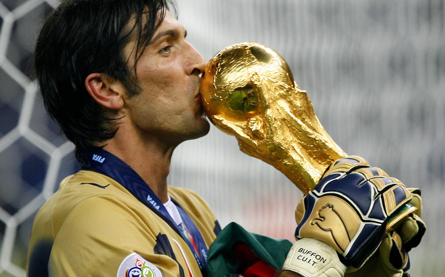 Italy&#039;s goal keeper Gianluigi Buffon kisses the World Cup trophy after the final of the soccer World Cup between Italy and France in the Olympic Stadium in Berlin, Sunday, July 9, 2006. Italy bea ...