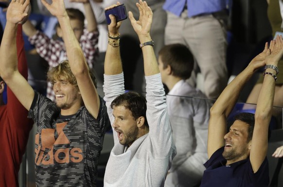 epa08485623 (L-R) Alexander Zverev of Germany, Grigor Dimitrov of Bulgaria and Novak Djokovic of Serbia perform a Mexican wave during the final match between Filip Krajinovic of Serbia and Dominic Thi ...