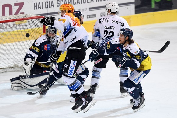 from left Ambri&#039;s goalkeeper Benjamin Conz,Gotteron’s player Julien Sprunger, Gotteron’s player Jim Slater and Ambri&#039;s player Samuel Guerra, during the preliminary round game of National Lea ...