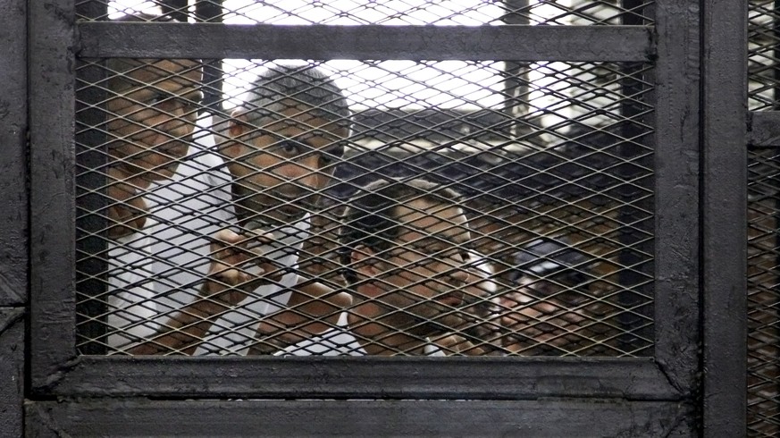 FILE - In this Monday, June 23, 2014, file photo, from left, Australian correspondent Peter Greste, Canadian-Egyptian acting bureau chief of Al-Jazeera Mohamed Fahmy, and Egyptian producer Baher Moham ...