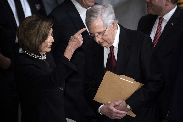 House Speaker Nancy Pelosi of Calif., and Senate Majority Leader Mitch McConnell, of Ky., talk before the start of a memorial service for Rep. Elijah Cummings, D-Md., in Statuary Hall at the U.S. Capi ...