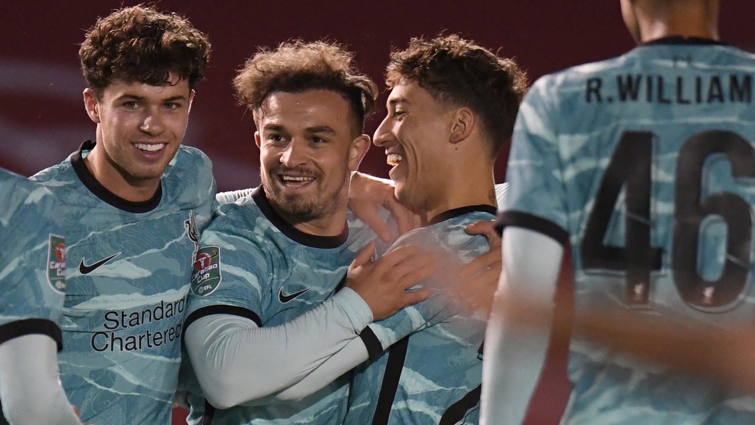 Liverpool&#039;s Xherdan Shaqiri, at centre, celebrates with teammates after scoring the opening goal of the game during the English League Cup third round soccer match between Lincoln City and Liverp ...