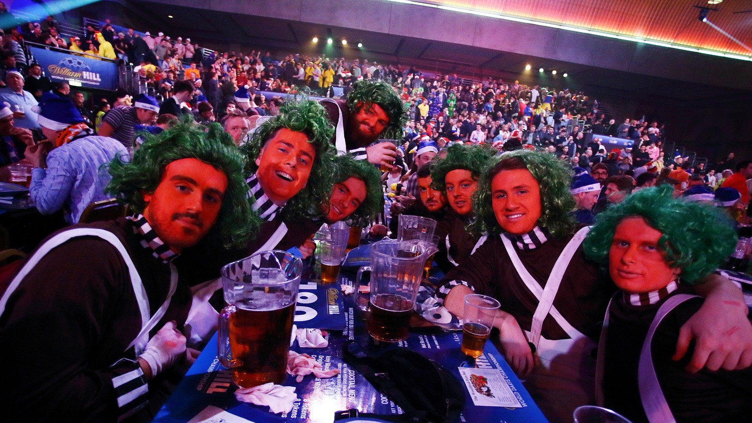 LONDON, ENGLAND - DECEMBER 27: Fans dressed as Oompa Loompa&#039;s enjoy the atmosphere during Day Seven of the William Hill PDC World Darts Championships at Alexandra Palace on December 27, 2014 in L ...