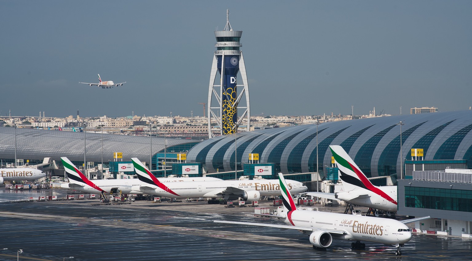 CORRECTS TO SAY THAT EMIRATES HAS DRAMATICALLY CUT ITS PASSENGER FLIGHT DESTINATIONS AND NOT SUSPENDED ALL FLIGHTS. -- FILE - In this Dec. 11, 2019 file photo, an Emirates jetliner comes in for landin ...