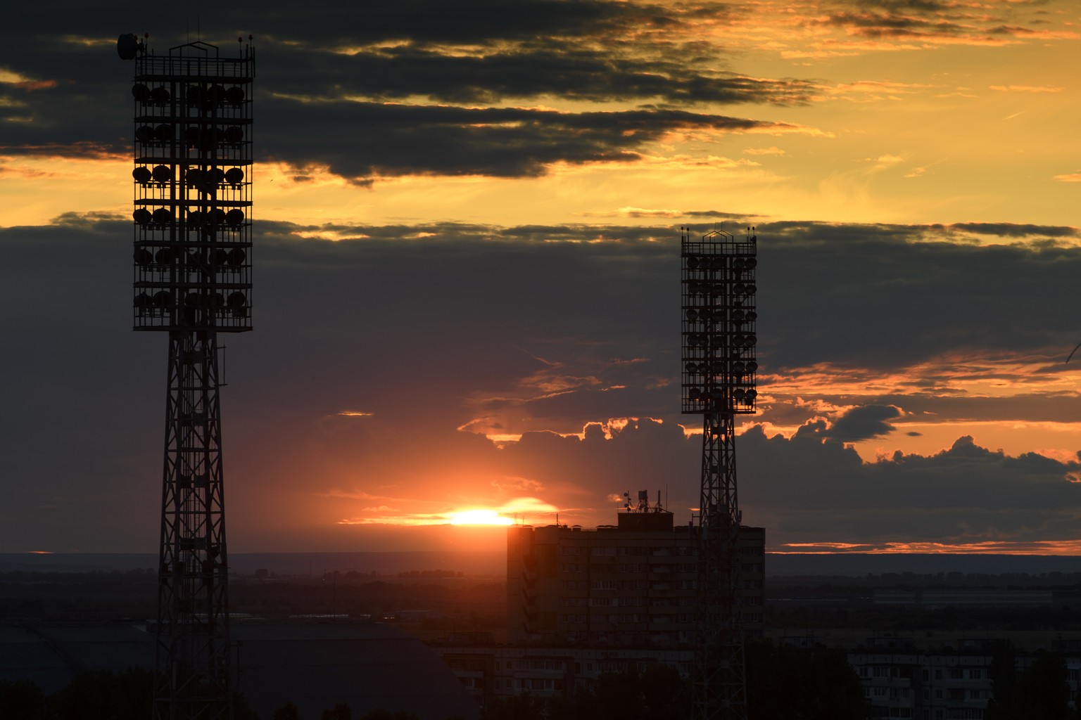 The sun sets behind lighting masts of the Torpedo Stadium where the Switzerland&#039;s national soccer team practice, in Togliatti, Russia, Monday, June 11, 2018. The Swiss team arrived in Russia for  ...