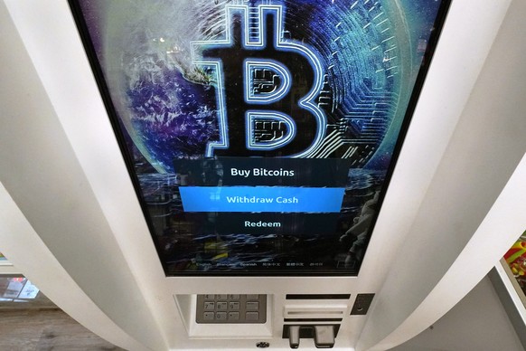 The Bitcoin logo appears on the display screen of a crypto currency ATM at the Smoker&#039;s Choice store, Tuesday, Feb. 9, 2021, in Salem, N.H. After a wild week in which Bitcoin soared to new height ...