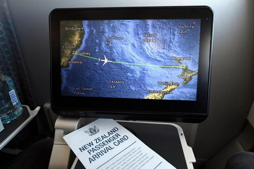 IN FLIGHT - APRIL 19: A screen aboard QANTAS flight QF143 displays the plane&#039;s fight path as it travels from Australia to New Zealand on April 19, 2021. The trans-Tasman travel bubble between New ...