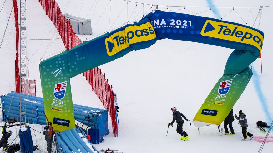 Volunteers remove banner from the finish line after the cancellation due to the fog of the Women&#039;s Super-G race at the 2021 FIS Alpine Skiing World Championships in Cortina d&#039;Ampezzo, Italy, ...