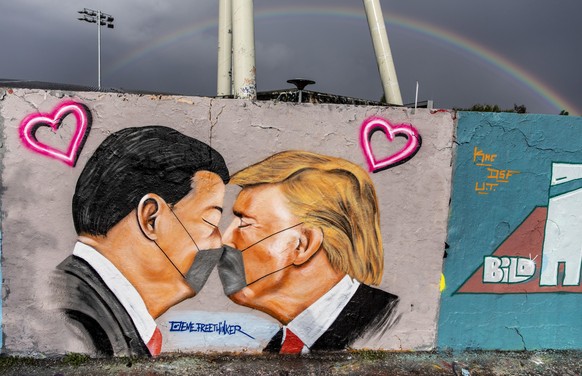 epa08414092 (FILE) - A mural by the street artist EME Freethinker of US President Donald Trump and President of the People&#039;s Republic of China Xi Jinping kissing as they wear surgical masks at Ma ...