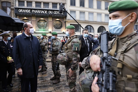 epa08788845 French Prime Minister Jean Castex (L) visits the French ground army soldiers of the Sentinelle force patrol at the cathedral Notre-Dame of Rouen, northwestern France, 31 October 2020, to m ...