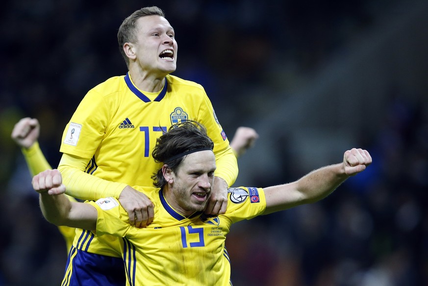 Sweden&#039;s Gustav Svensson and Viktor Claesson, top, celebrate at the end of the World Cup qualifying play-off second leg soccer match between Italy and Sweden, at the Milan San Siro stadium, Italy ...