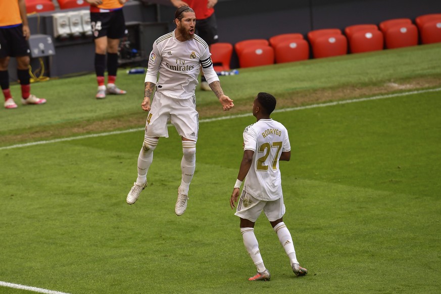 Real Madrid&#039;s Sergio Ramos, left, celebrates after scoring the opening goal from a penalty shoot during the Spanish La Liga soccer match between Athletic Club and Real Madrid at the San Manes sta ...