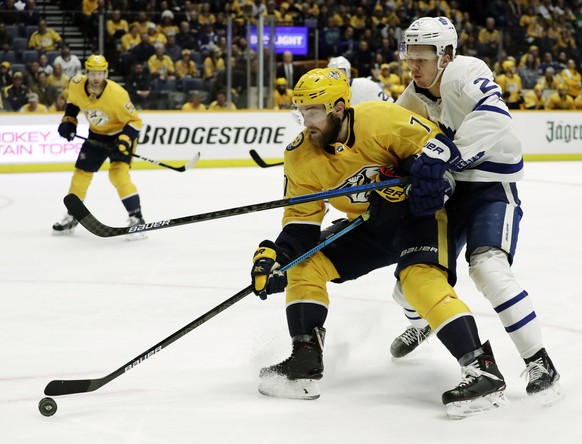 Toronto Maple Leafs right wing Kasperi Kapanen (24), of Finland, slows down Nashville Predators defenseman Yannick Weber (7), of Switzerland, in the first period of an NHL hockey game Tuesday, March 1 ...