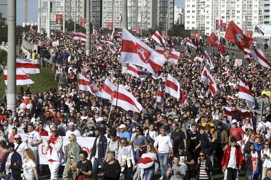 Protesters with old Belarusian national flags march during a Belarusian opposition supporters&#039; rally protesting the official presidential election results in Minsk, Belarus, Sunday, Sept. 13, 202 ...