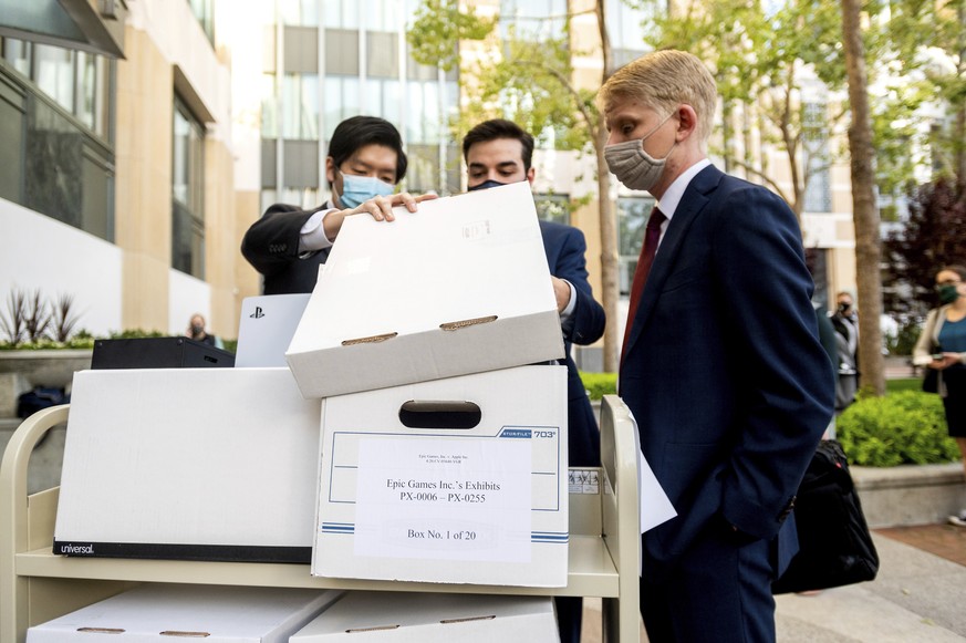 Members of Epic Games&#039; legal team roll exhibit boxes into the Ronald V. Dellums building in Oakland, Calif., for the company&#039;s lawsuit against Apple on Monday, May 3, 2021. Epic, maker of th ...