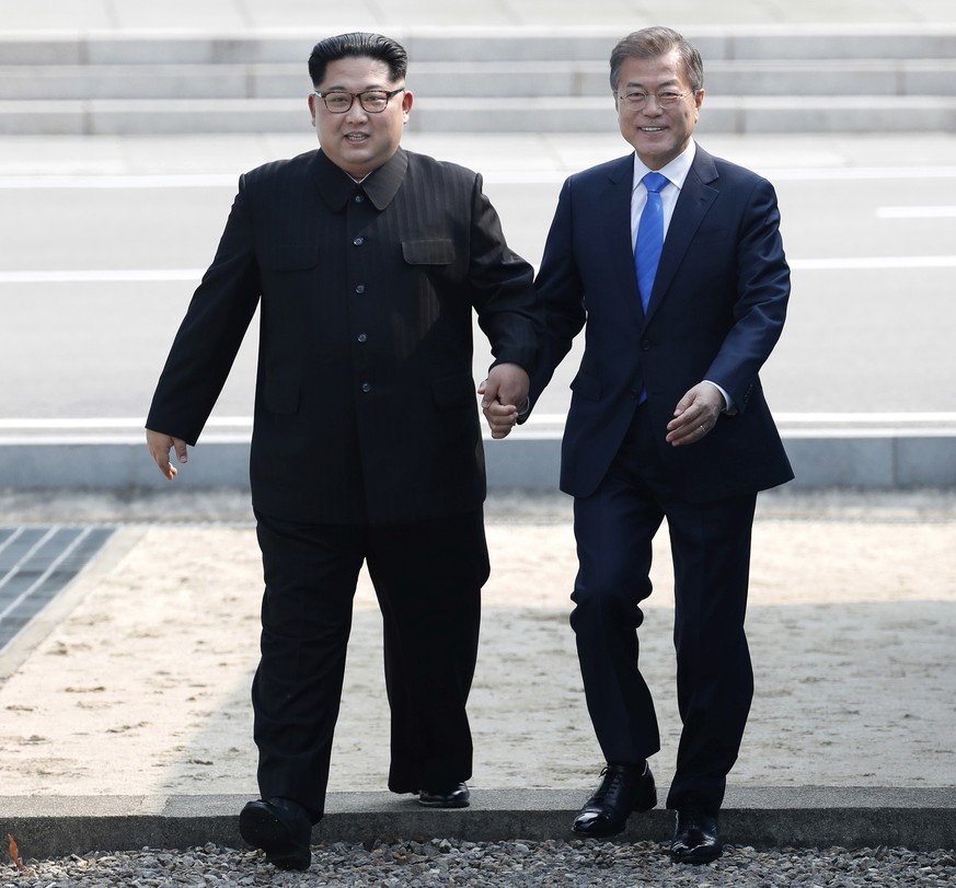 In this April 27, 2018, file photo, North Korean leader Kim Jong Un, left, and South Korean President Moon Jae-in cross the military demarcation line to the South side at the border village of Panmunj ...