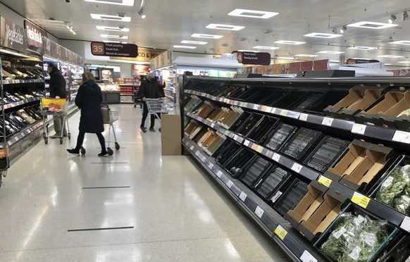 Depleted shelves are seen in a Sainsbury&#039;s supermarker at the Forestside shopping centre in Belfast, Monday, Jan. 11, 2021. The U.K.���s biggest supermarket chains warned Wednesday, Jan. 13 that  ...