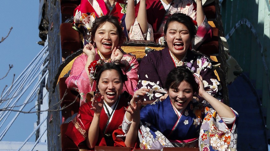 epa07281963 Kimono-clad 20-year-old Japanese women scream as they ride a roller coaster following a ceremony to celebrate Coming-of-Age Day at Toshimaen amusement park in Tokyo, Japan, 14 January 2019 ...