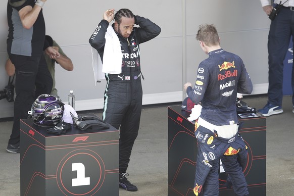 epa08605509 British Formula One driver Lewis Hamilton of Mercedes-AMG Petronas (L) and Dutch Formula One driver Max Verstappen of Aston Martin Red Bull Racing (R) after the qualifying session of the F ...