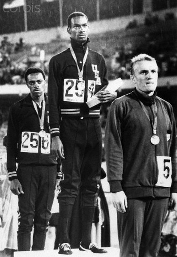 19 Oct 1968, Mexico City, Mexico --- American Bob Beamon stands on the victory stand after winning the long jump competition with a world-record jump at the 1968 Summer Olympics. American Ralph Boston ...