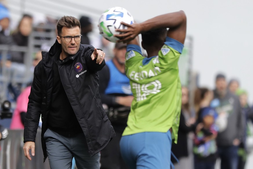 Chicago Fire head coach Raphael Wicky, left, gestures as Seattle Sounders defender Kelvin Leerdam throws the ball in during the first half of an MLS soccer match, Sunday, March 1, 2020, in Seattle. (A ...