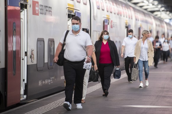 Pendler mit Atemschutzmasken bewegen sich auf dem Hauptbahnhof in Zuerich, aufgenommen am Montag, 6. Juli 2020. (KEYSTONE/Ennio Leanza)