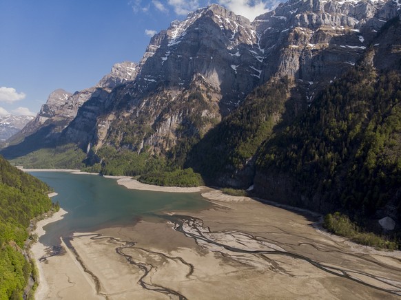 epa08380279 An aerial picture taken with a drone shows a general view on the Kloental lake with a low water level in Glarus, Switzerland, 23 April 2020. EPA/GIAN EHRENZELLER