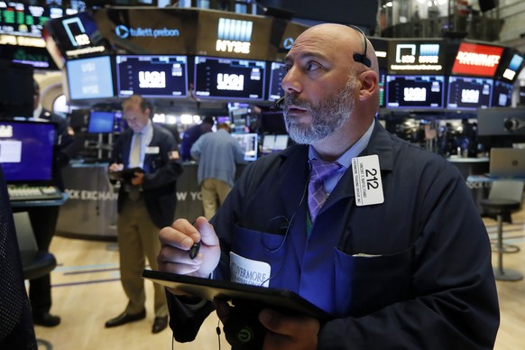 Trader Vincent Napolitano works on the floor of the New York Stock Exchange, Monday, July 1, 2019. Wall Street applauded a cease-fire in the U.S. trade war with China and opened trading in July with a ...