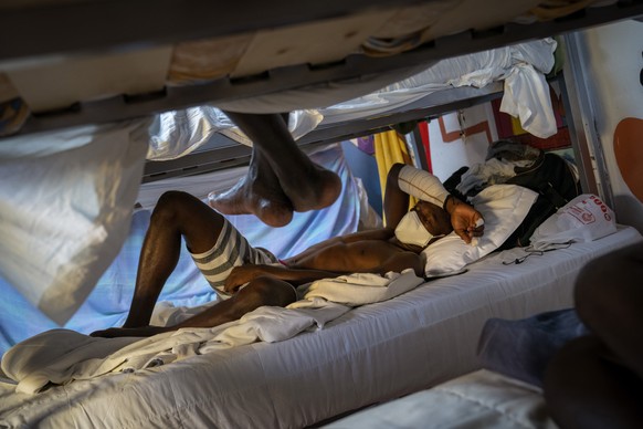 Hady Baye, 31, rests in a bunk bed at the Modern Christian Mission Church in Fuerteventura, one of the Canary Islands, Spain, on Saturday, Aug. 22, 2020. The Modern Christian Mission is the main shelt ...