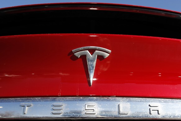FILE - In this Feb. 2, 2020, file photo, the company logo sits on an unsold 2020 Model X at a Tesla dealership in Littleton, Colo. The company said it made $16 million from January through March, or 8 ...