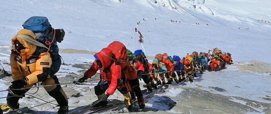 FILE - In this May 22, 2019, file photo, a long queue of mountain climbers line a path on Mount Everest just below camp four, in Nepal. Expedition operators on Mount Everest say that Chinese mountaine ...