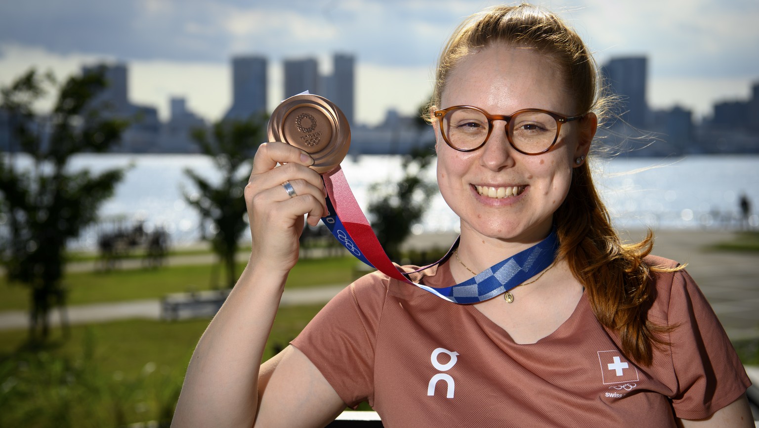 Nina Christen of Switzerland poses with her bronze medal before a virtual press conference after the women&#039;s shooting 10m air rifle finals at the 2020 Tokyo Summer Olympics in Tokyo, Japan, on Sa ...