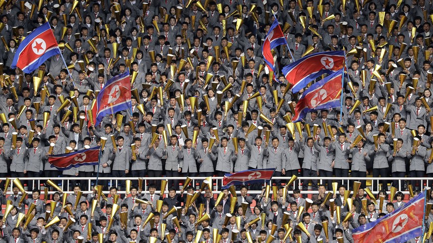 FILE - In this April 7, 2017, file photo, North Korean university students cheer and wave their national flag as their country&#039;s women&#039;s soccer team competes against South Korea in a qualify ...