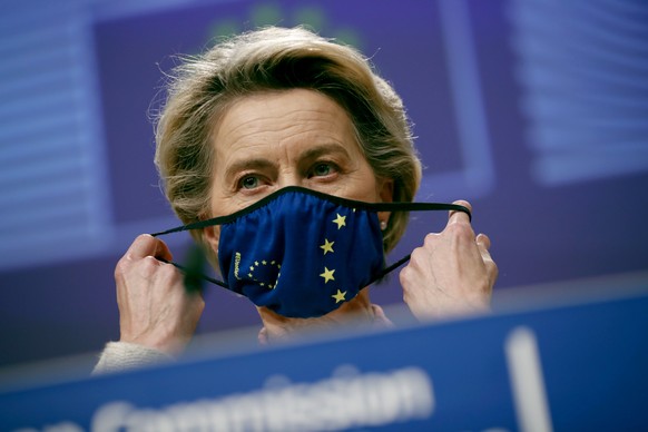 European Commission President Ursula von der Leyen puts on her protective face mask after addressing a media conference on Brexit negotiations at EU headquarters in Brussels, Thursday, Dec. 24, 2020.  ...